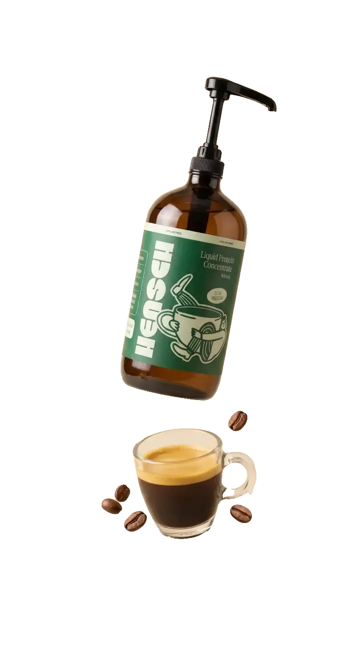 A floating Hensch bottle pumping liquid protein into a glass of espresso